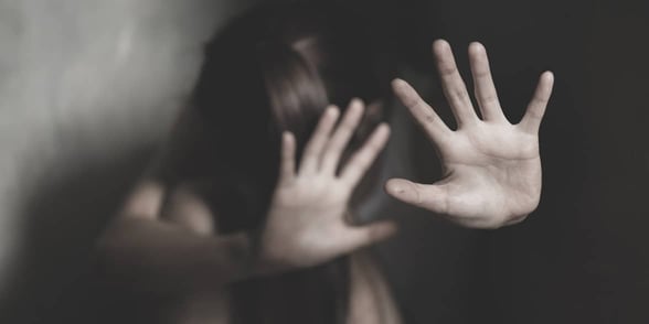 Photo of a woman holding her hands up