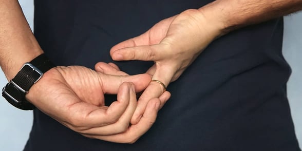 Photo of a man taking off his wedding ring