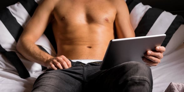 Photo of a man in bed by himself Photo of a man in bed by himself