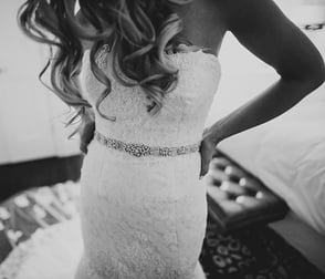 Photo of a bride trying on a wedding dress at Bridal Reflections