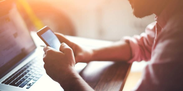 Photo of a man texting