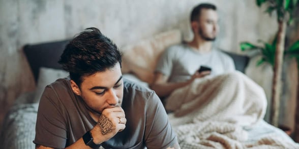 Photo of sad gay couple on a bed Photo of sad gay couple on a bed