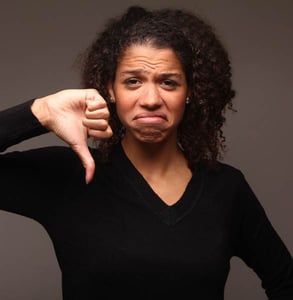 Photo of a woman with her thumb down Photo of a woman with her thumb down