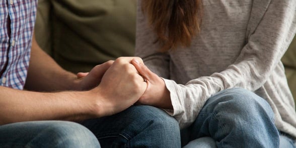 Photo of a couple holding hands