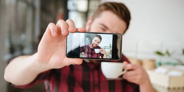 Photo of a man taking a selfie Photo of a man taking a selfie