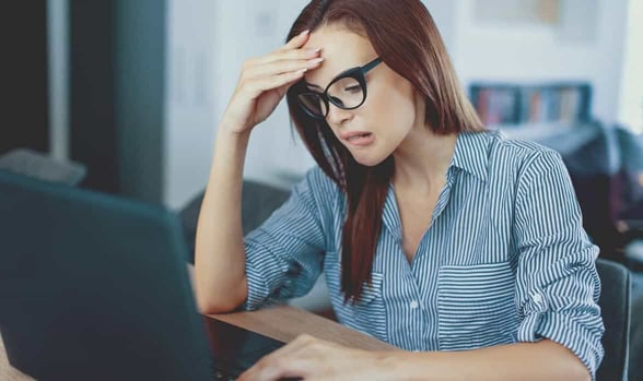 Photo of woman staring at laptop