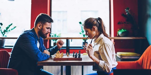 Photo of a couple playing chess