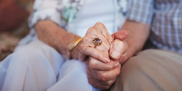 Photo of mature couple holding hands