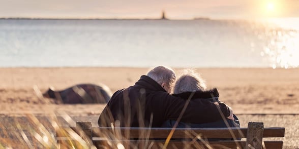 Photo of an older couple on the beach