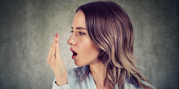 Photo of a woman smelling her breath