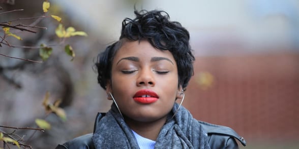 Photo of a woman taking deep breaths