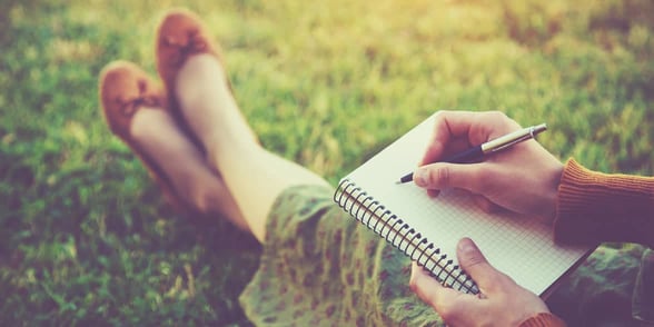 Photo of woman writing in journal