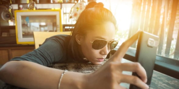 Photo of sad woman staring at cellphone