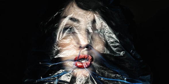 Photo of woman with bag over head