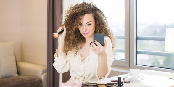 Photo of woman putting on makeup Photo of woman putting on makeup