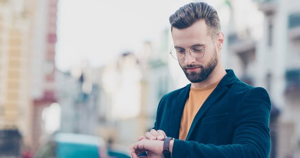 Photo of man looking at watch