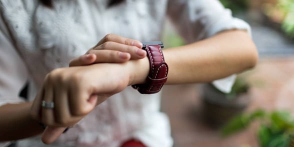 Photo of woman looking at watch