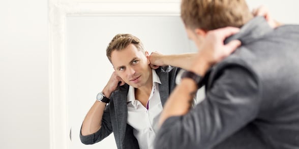 Photo of a man getting dressed