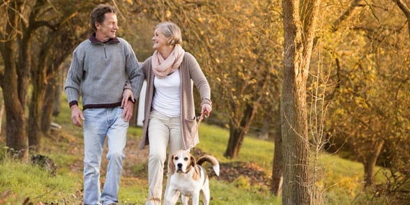 Photo of mature couple walking arm in arm