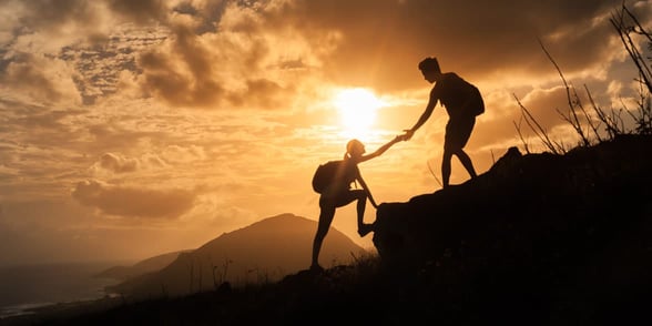 Photo of people helping each other