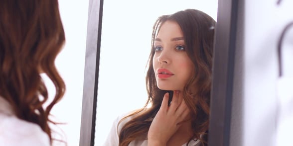 Photo of woman looking in mirror