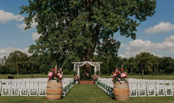 Photo of outdoor daytime wedding setup