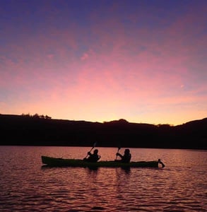 Photo of two people kayaking