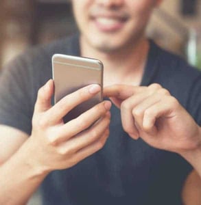 Photo of a man on his phone
