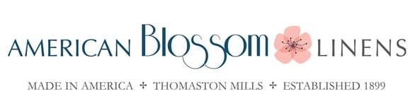 The American Blossom Linens logo