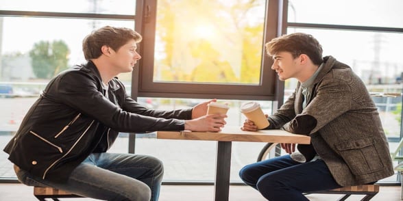 Photo of two men having a drink