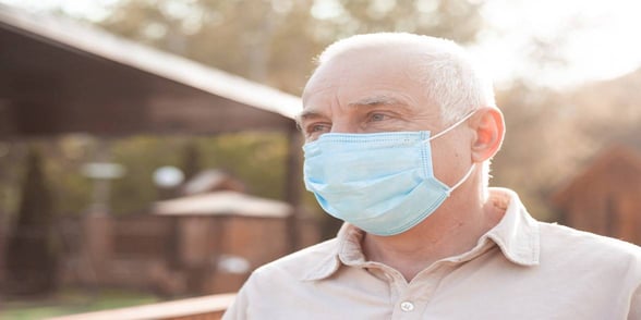 Photo of a man wearing a mask