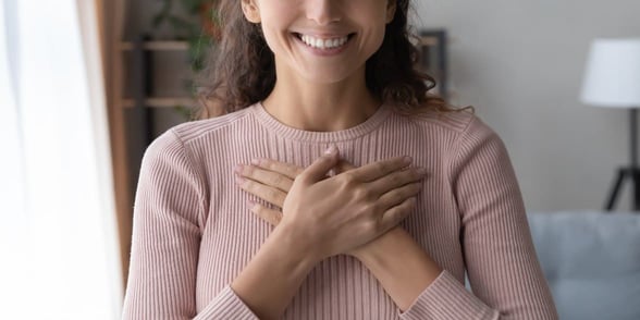 Photo of a woman holding her heart Photo of a woman holding her heart