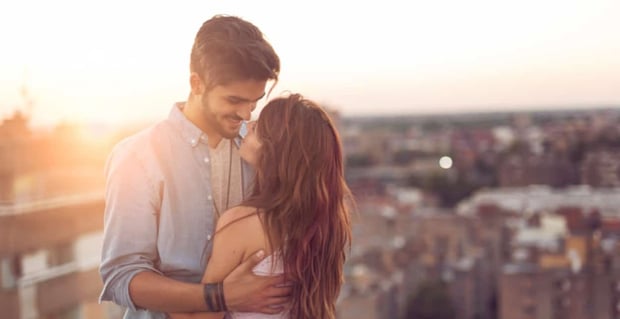 A couple embracing under the sunset
