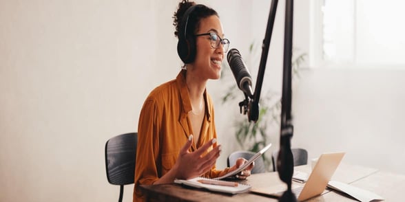 Photo of a woman podcasting