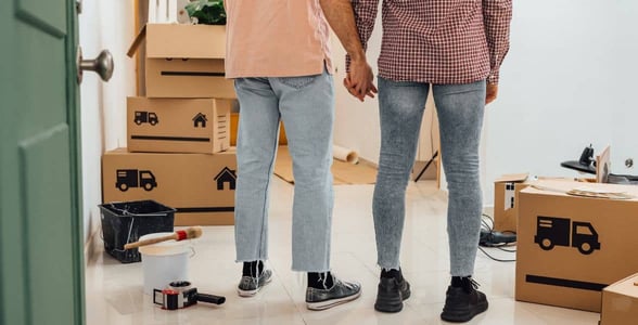 Photo of two men holding hands