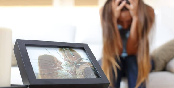 Photo of a woman and a broken picture frame Photo of a woman and a broken picture frame