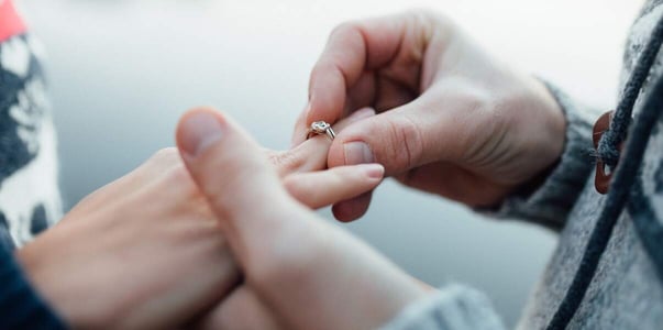 hand placing ring on finger