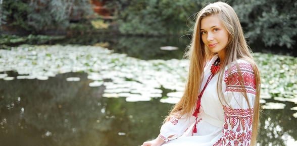 woman smiling by pond woman smiling by pond