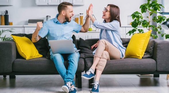 Photo of couple high-fiving Photo of couple high-fiving