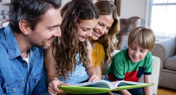 family looking at photo album.