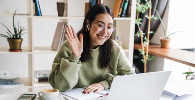 Photo of a woman saying hello on a video call Photo of a woman saying hello on a video call