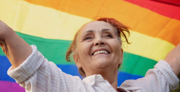 Photo of a woman with a rainbow flag