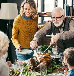 Photo of people having turkey dinner together