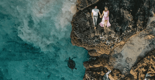 couple on rocks, turtle below