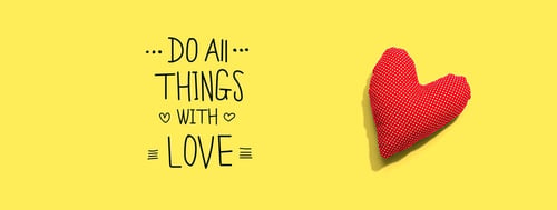 Do all things with love message with a red heart cushion - flat lay Do all things with love message with a red heart cushion - flat lay