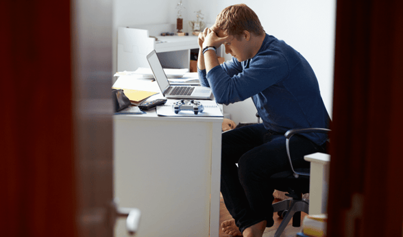 man distraught at laptop
