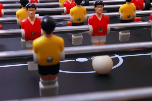 foosball table soccer little men playing game foosball table soccer little men playing game