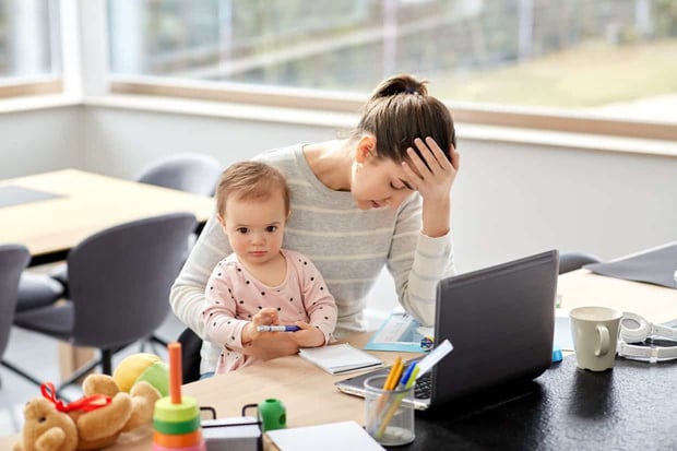 remote job, multi-tasking and family concept - tired mother with baby working at home office