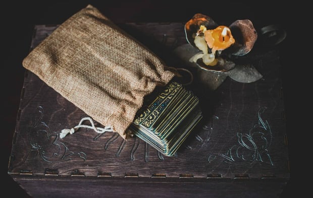A fortune teller, witch stuff on a table, candles and fortune-telling objects. The concept of divination, astrology and esotericism A fortune teller, witch stuff on a table, candles and fortune-telling objects. The concept of divination, astrology and esotericism