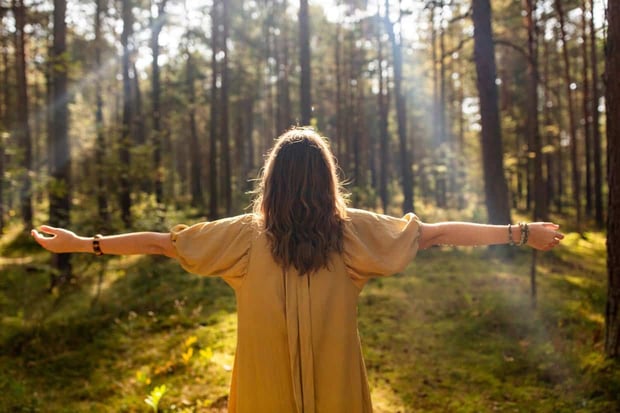 nature, spirituality and supernatural concept - young woman or witch performing magic ritual in forest nature, spirituality and supernatural concept - young woman or witch performing magic ritual in forest
